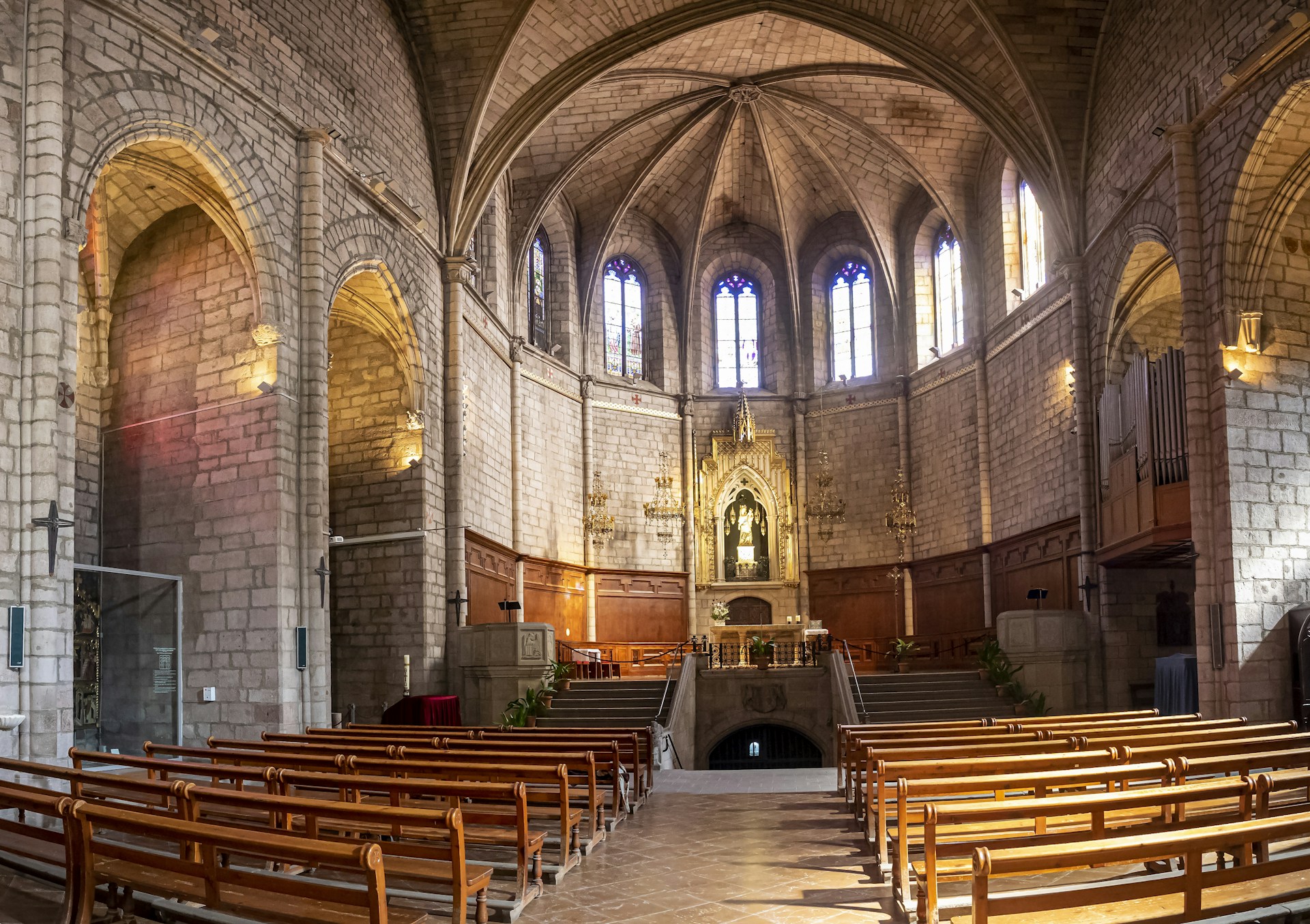 an empty church with pews and stained glass windows