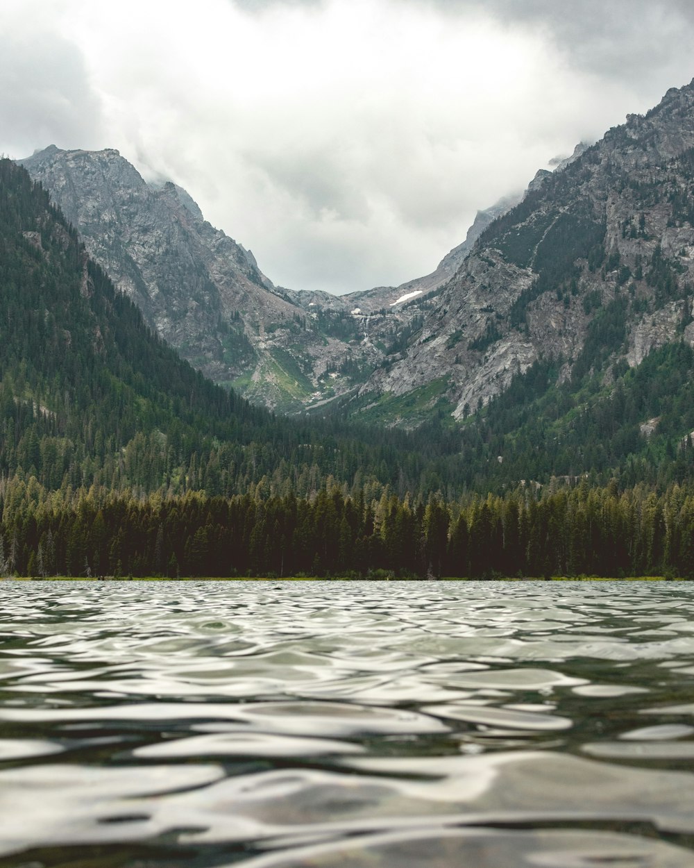 a body of water with mountains in the background