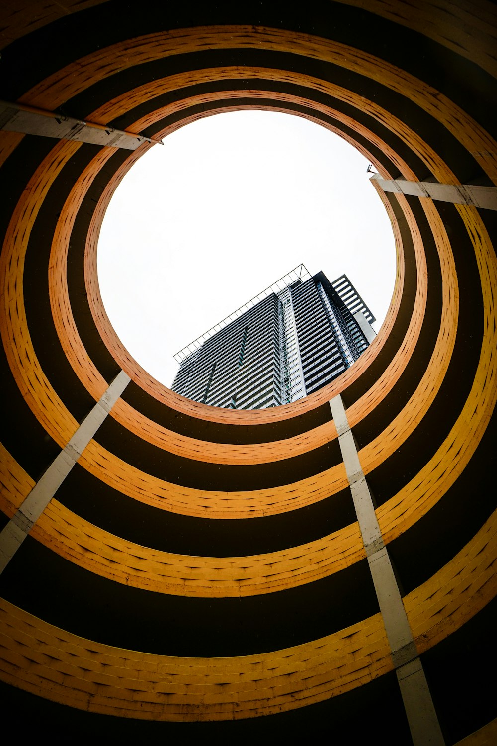 a tall building is seen through a circular hole