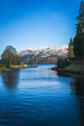 a body of water with a mountain in the background