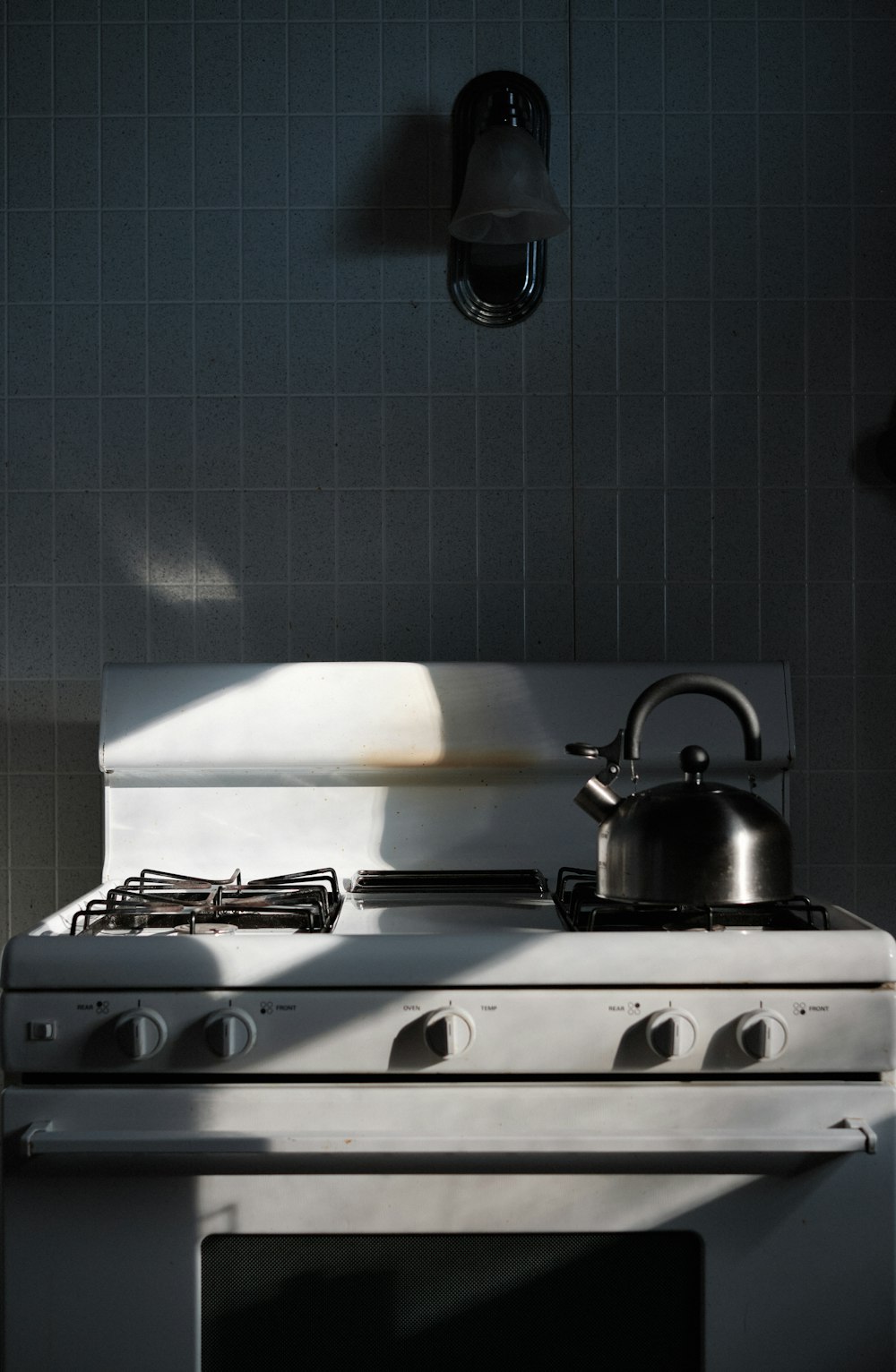 a stove with a tea kettle on top of it