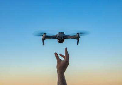 a hand holding a flying object in the air