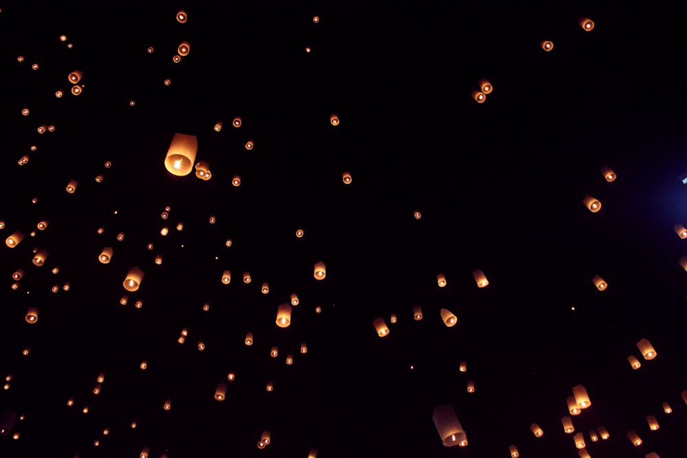 a lot of lanterns floating in the air