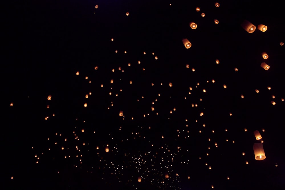 a lot of lanterns floating in the air