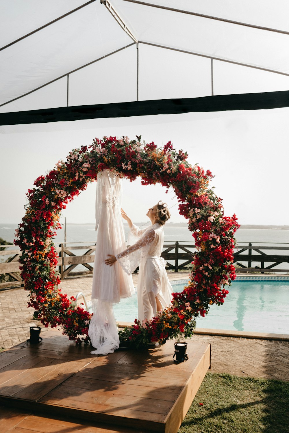 a couple of women standing next to each other near a pool