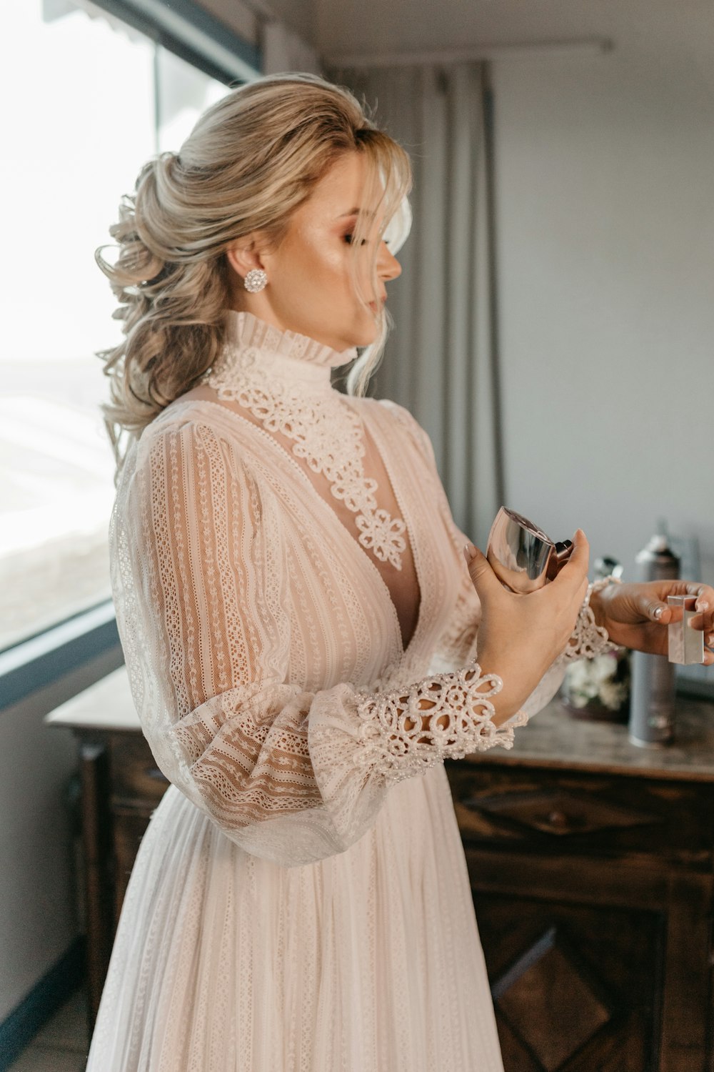 a woman in a white dress holding a glass of wine