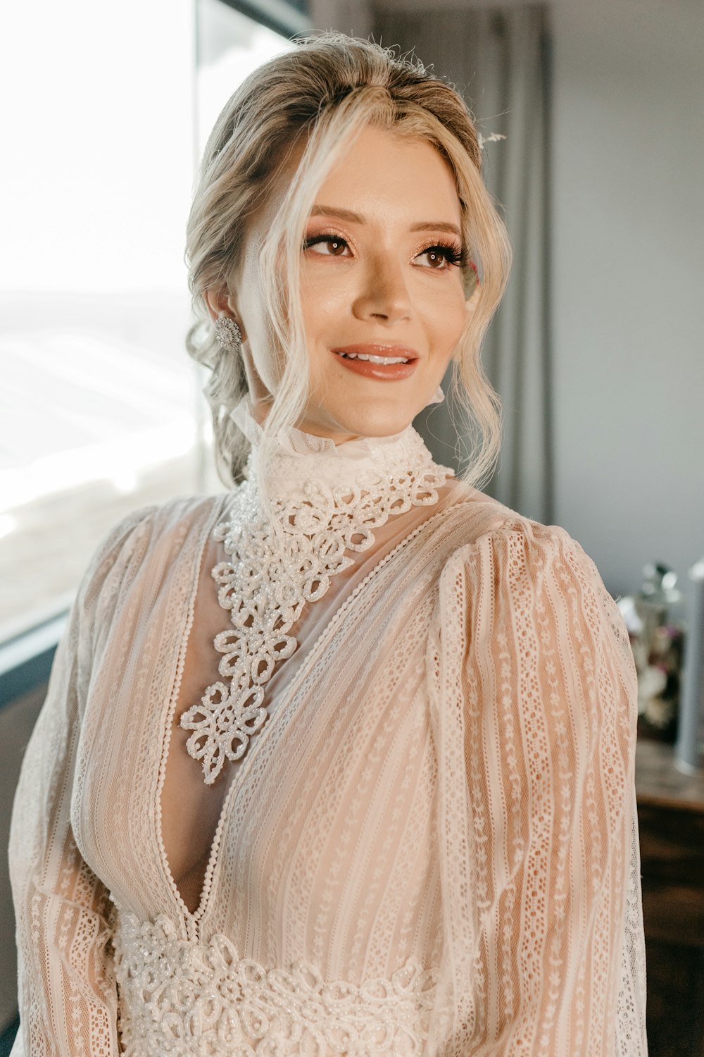 a woman in a white dress posing for a picture