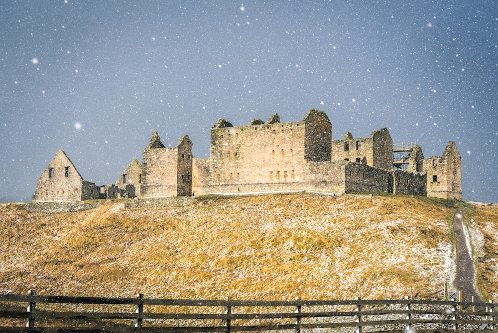a large castle sitting on top of a hill covered in snow