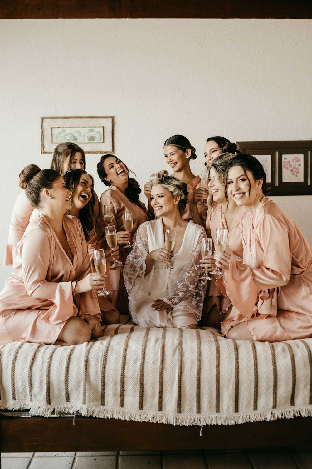 a group of women sitting on top of a bed