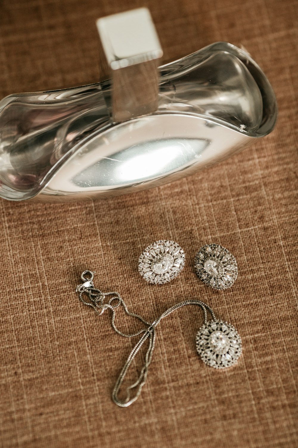a pair of dandelions and a pair of earrings on a table