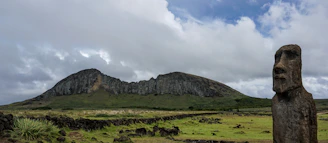 a large rock formation in the middle of a field