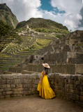 a woman in a yellow dress and a straw hat