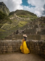 a woman in a yellow dress and a straw hat