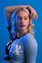 a woman with blonde hair is posing for a picture