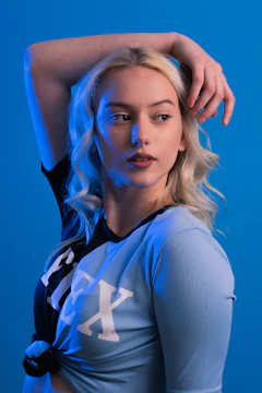 a woman with blonde hair is posing for a picture