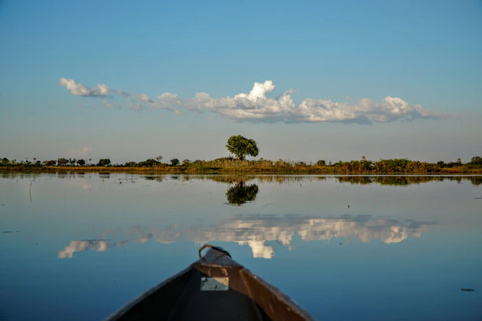 Mokoro bow reflected in a calm lagoon