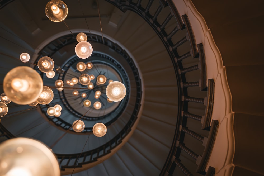 a spiral staircase with many lights hanging from it