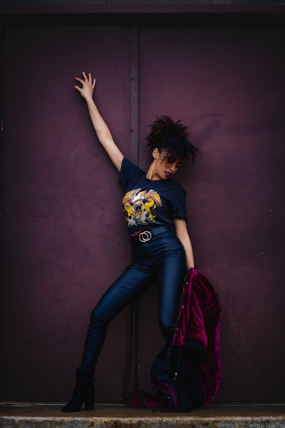 a woman leaning against a purple wall Agencia La Movida Marca Personal