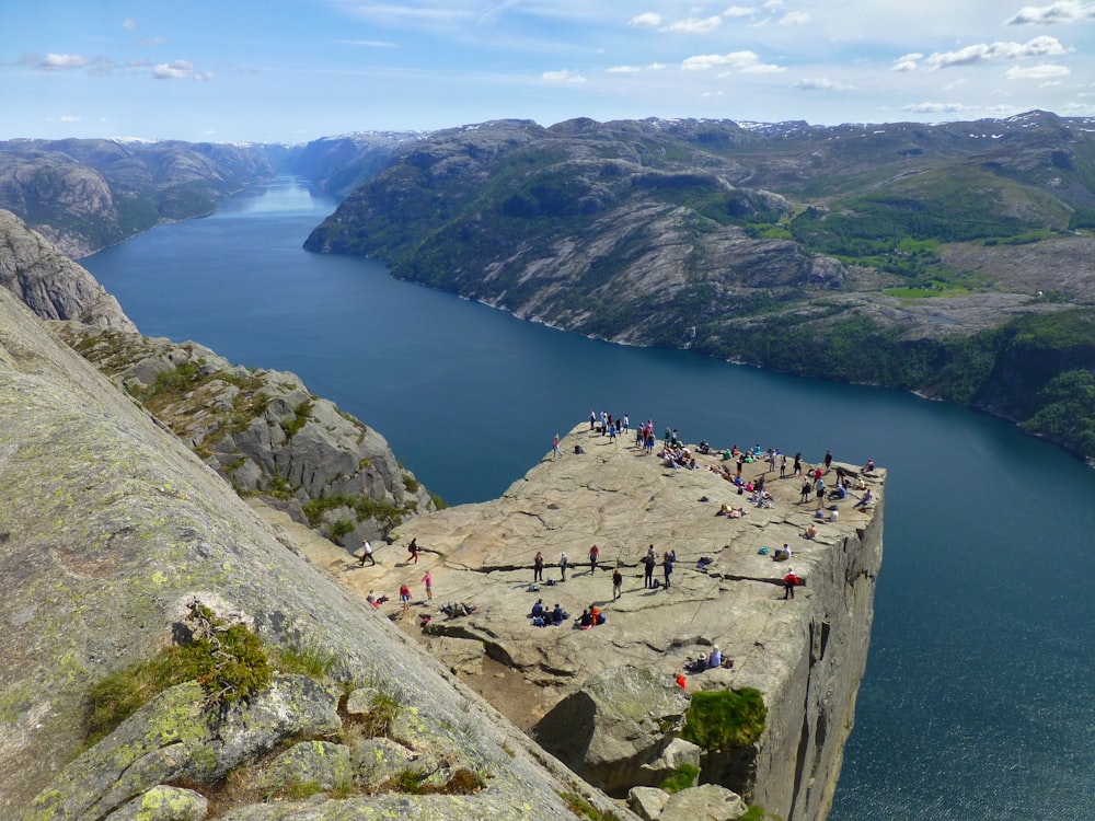 a group of people standing on top of a cliff