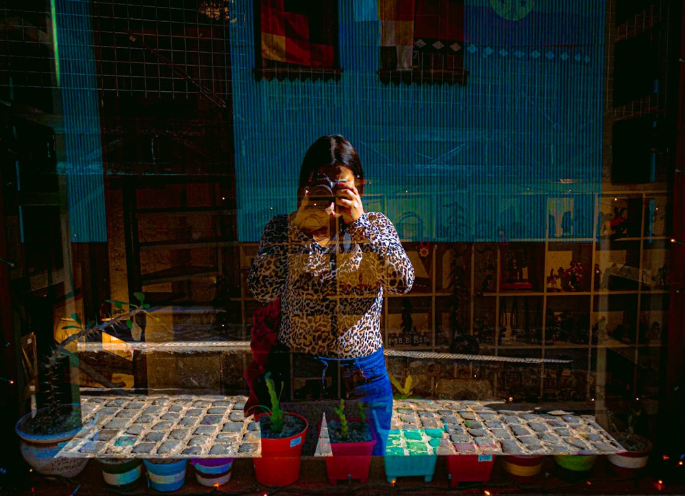 a woman taking a picture of herself in a mirror