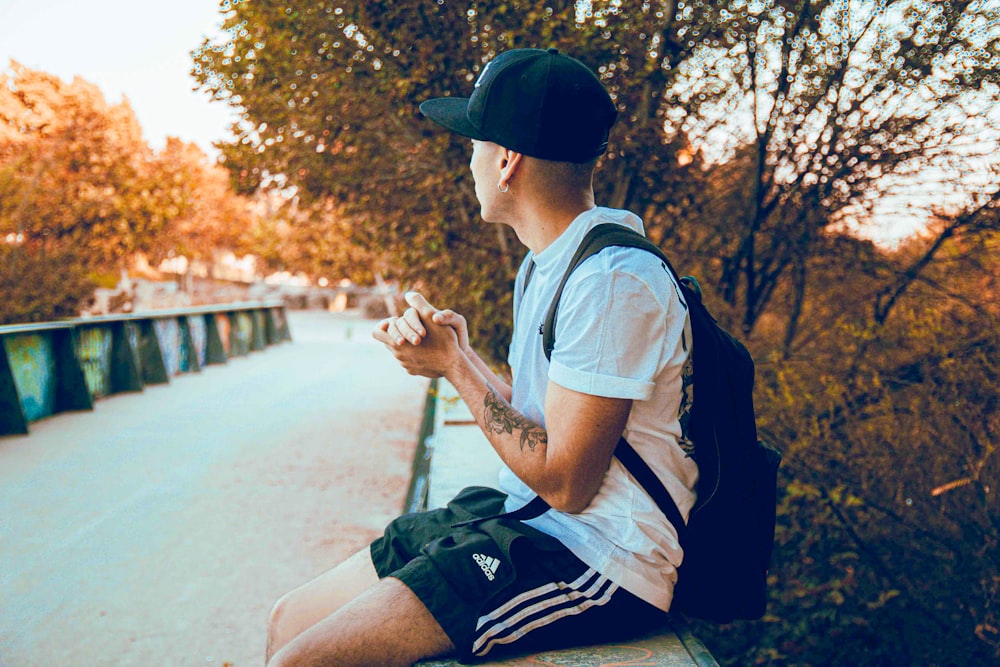 a man sitting on a bench looking at his cell phone