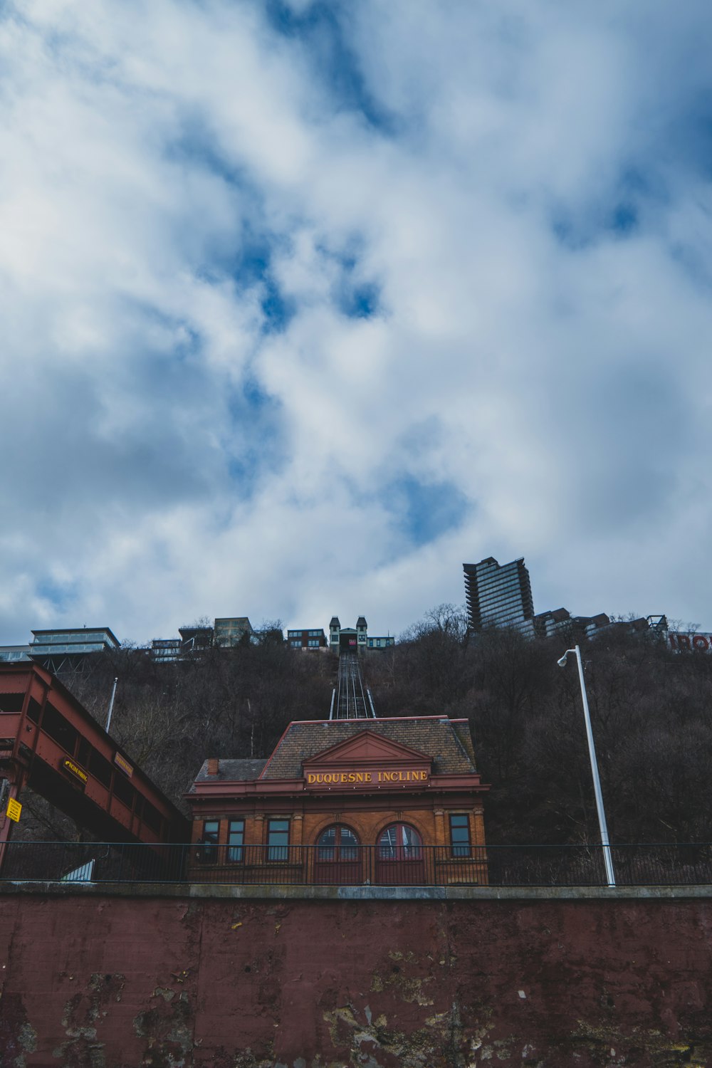 a train station sitting on top of a brick wall