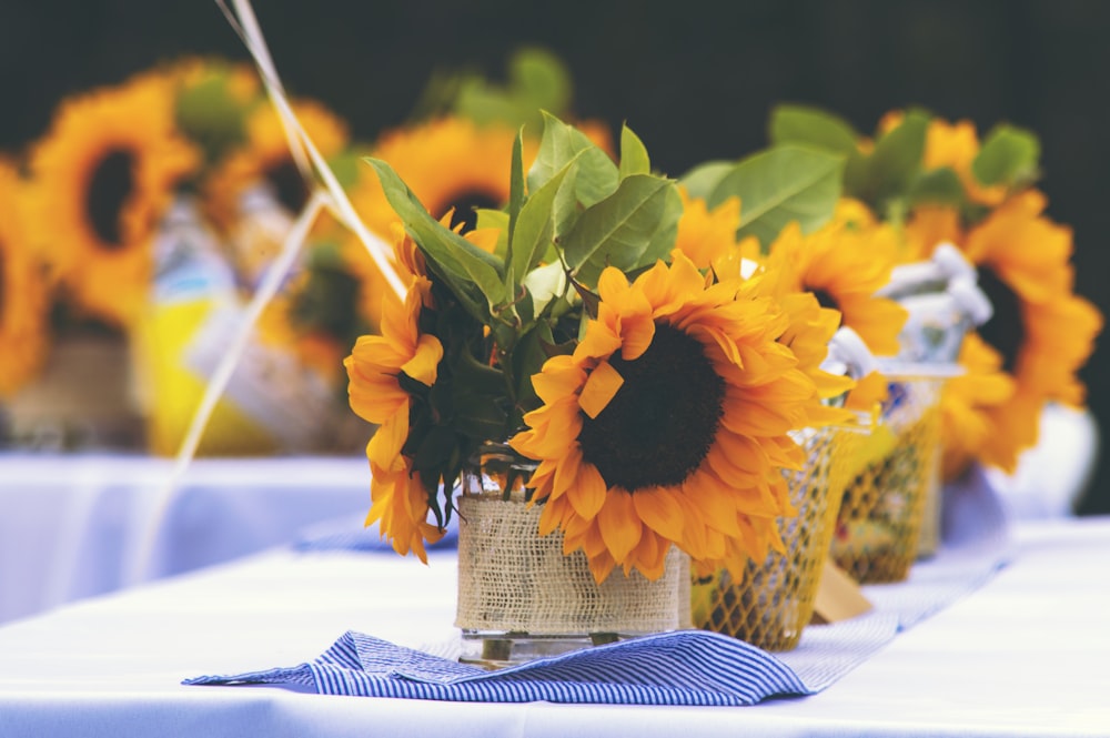 a bunch of sunflowers in a vase on a table