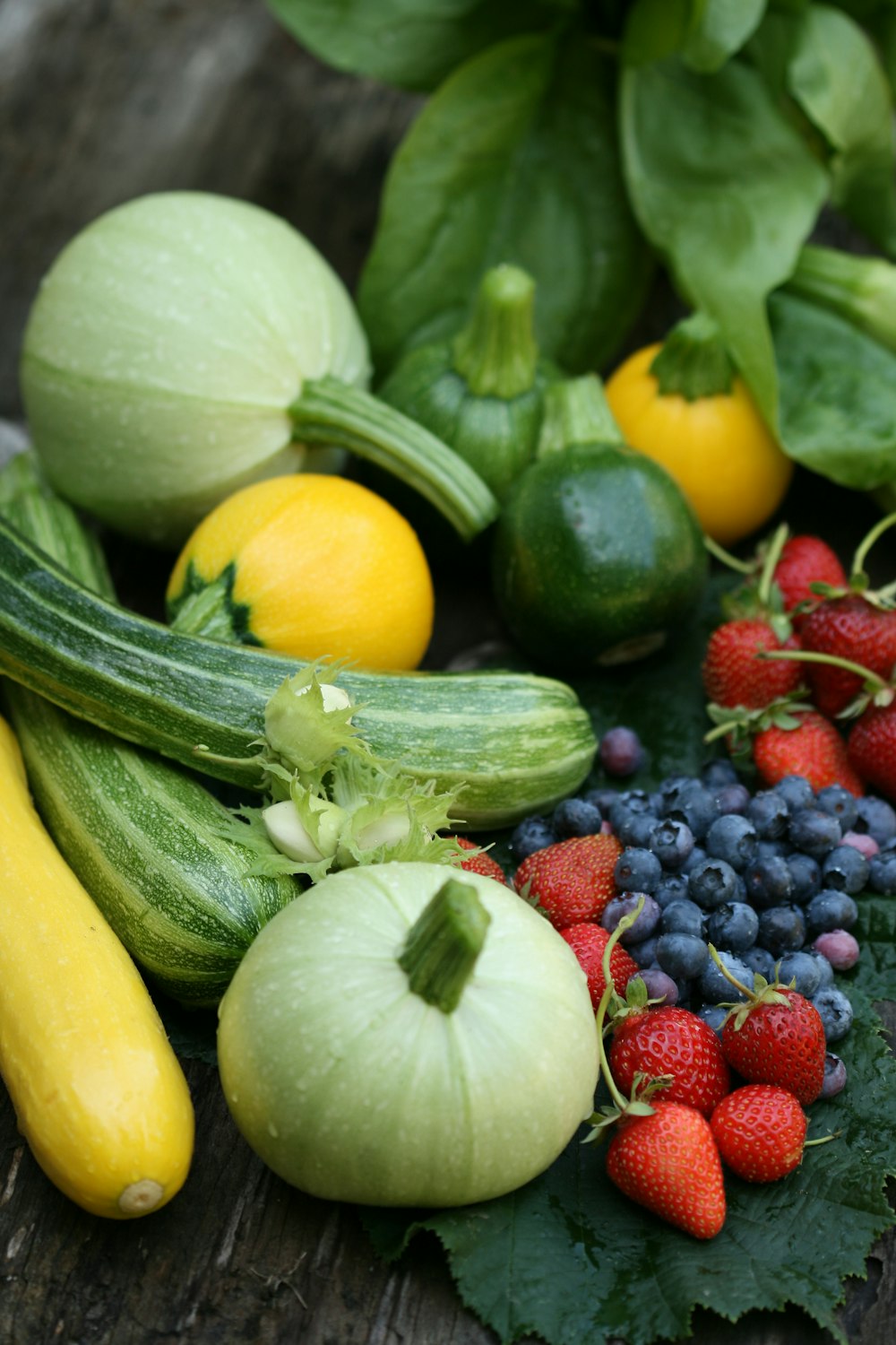 a variety of fruits and vegetables sitting on a table