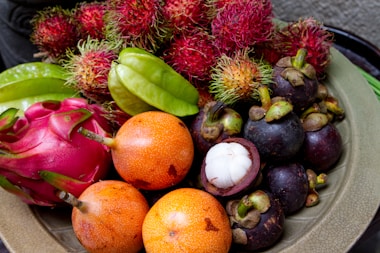Bowl filled with different types of exotics of fruit.