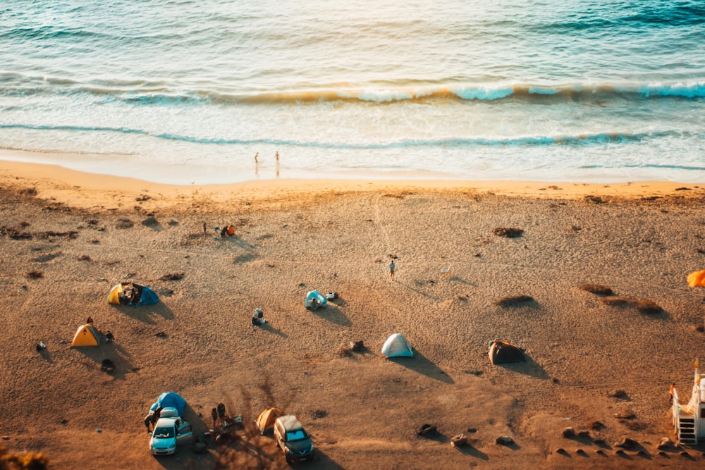 a beach with a few boats and people on it