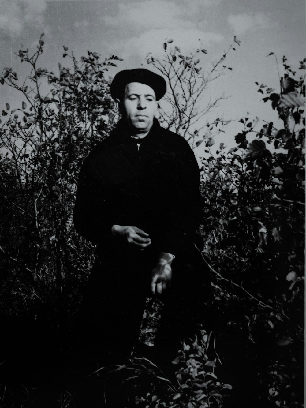 a black and white photo of a woman in a hat