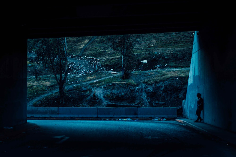 a dark tunnel with a person standing in it