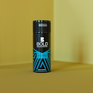 A can of deodorant, labeled BOLD, stands upright against a yellow background. The bottle features a sleek black design with blue geometric patterns and the word ALPHA written on it.
