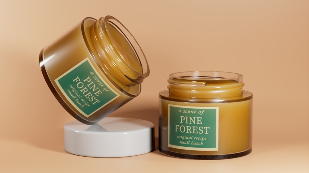 a jar of pine forest candle next to a jar of honey