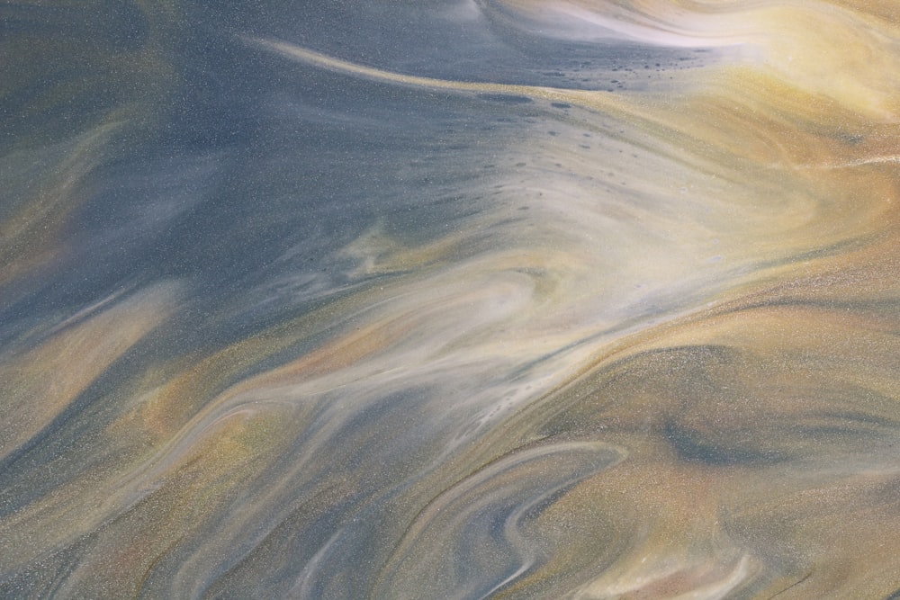 an abstract painting of a blue, yellow, and white swirl