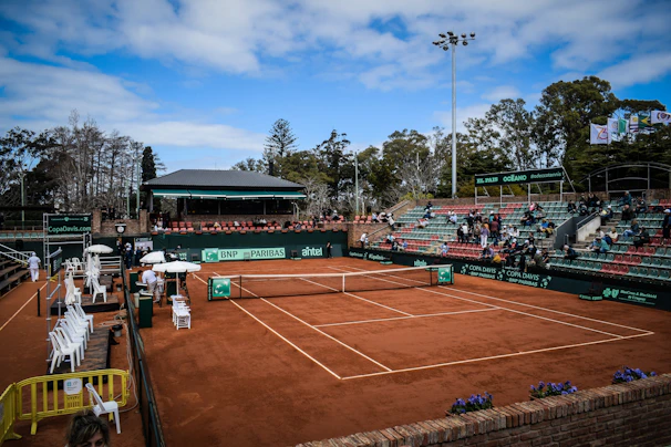 Sponsors' banners displayed prominently around the padel courts during a tournament.