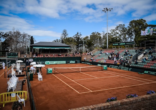 a tennis court with a crowd of people watching it