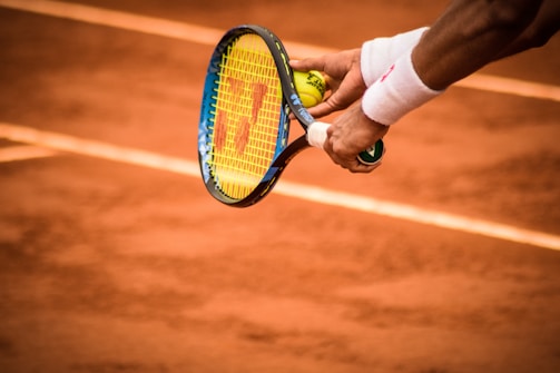 Close-up of a player’s hands gripping a padel racket preparing for a serve.