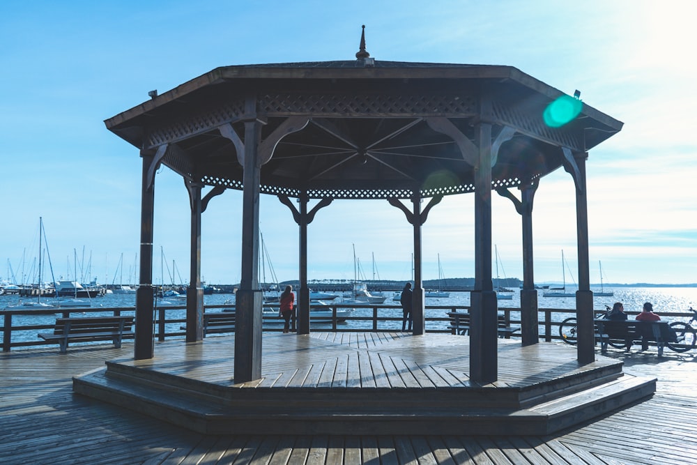 a gazebo sitting on top of a wooden pier