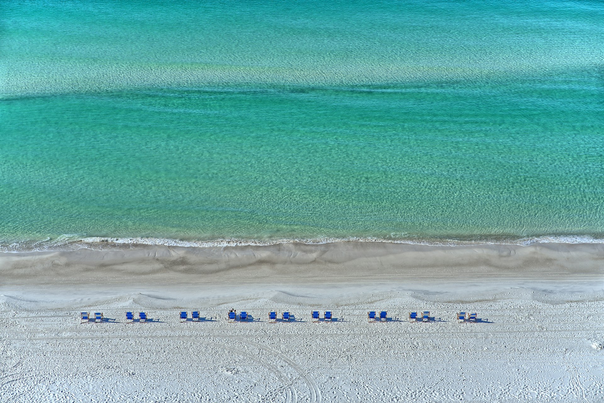 Aerial view of white sand beach and emerald water in Panama City Beach Florida