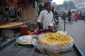 A vibrant street food pod with sizzling samosas frying in hot oil, surrounded by colorful spices and happy customers in Vadodara.
