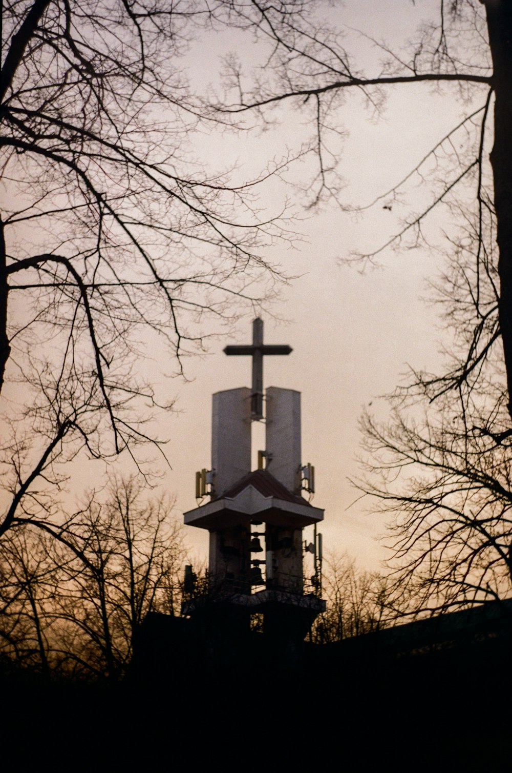 a church steeple with a cross on top of it