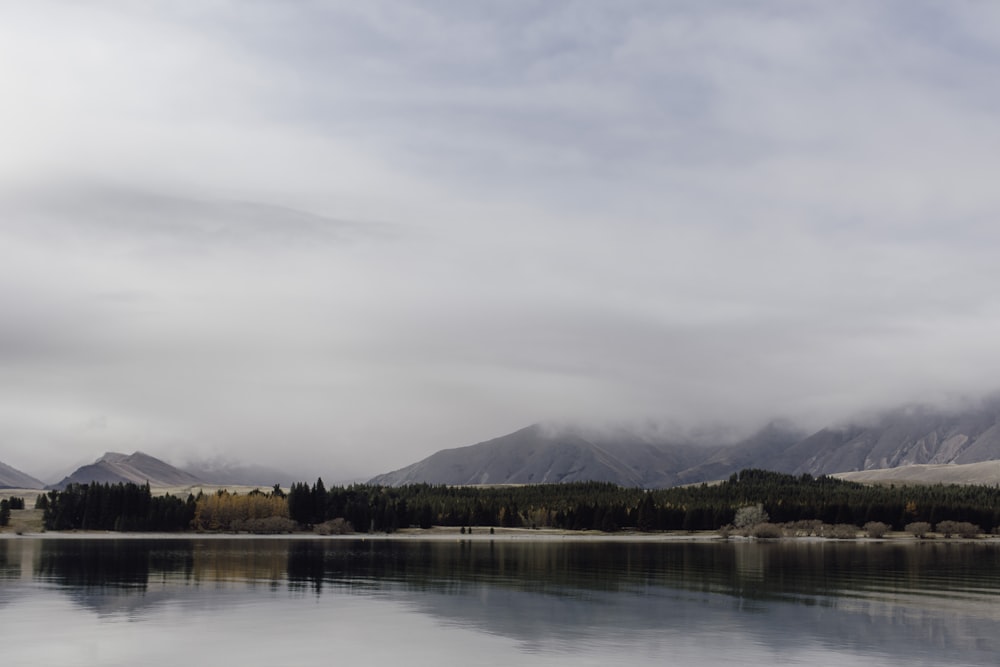 a body of water with mountains in the background