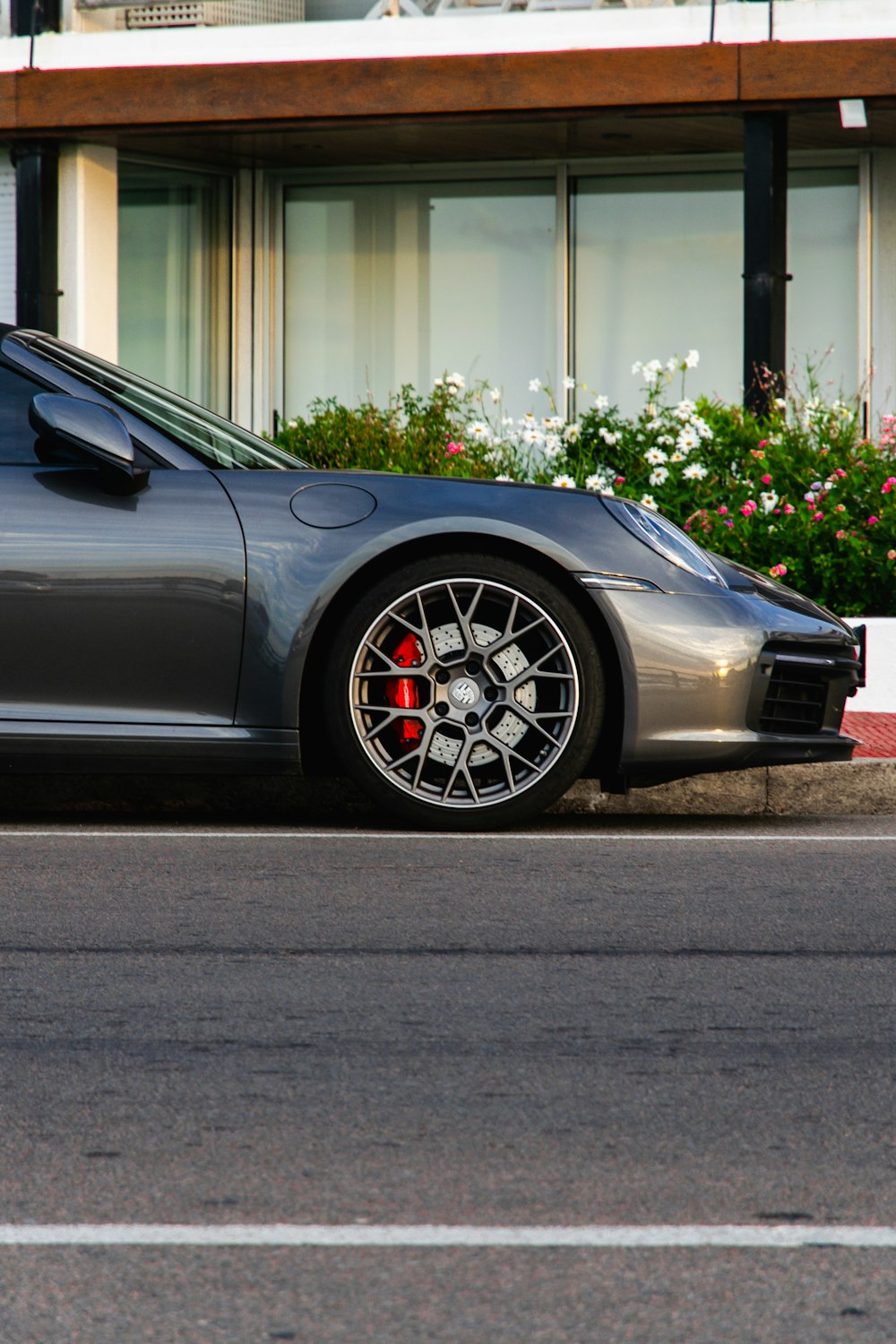 a silver sports car parked in front of a building