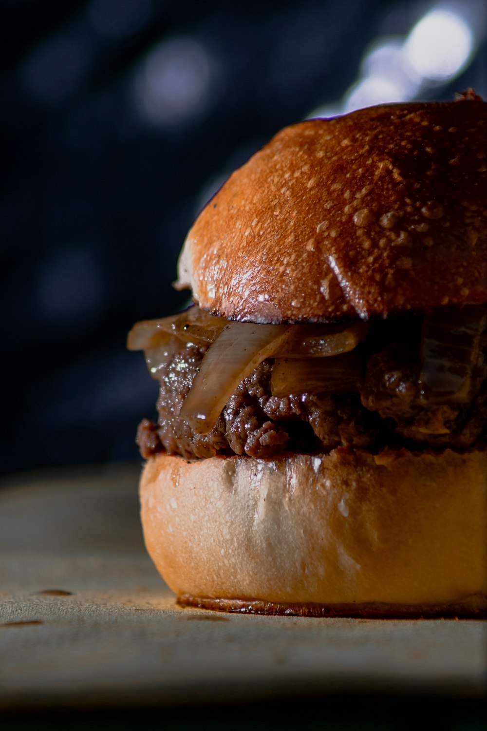 a hamburger sitting on top of a wooden cutting board