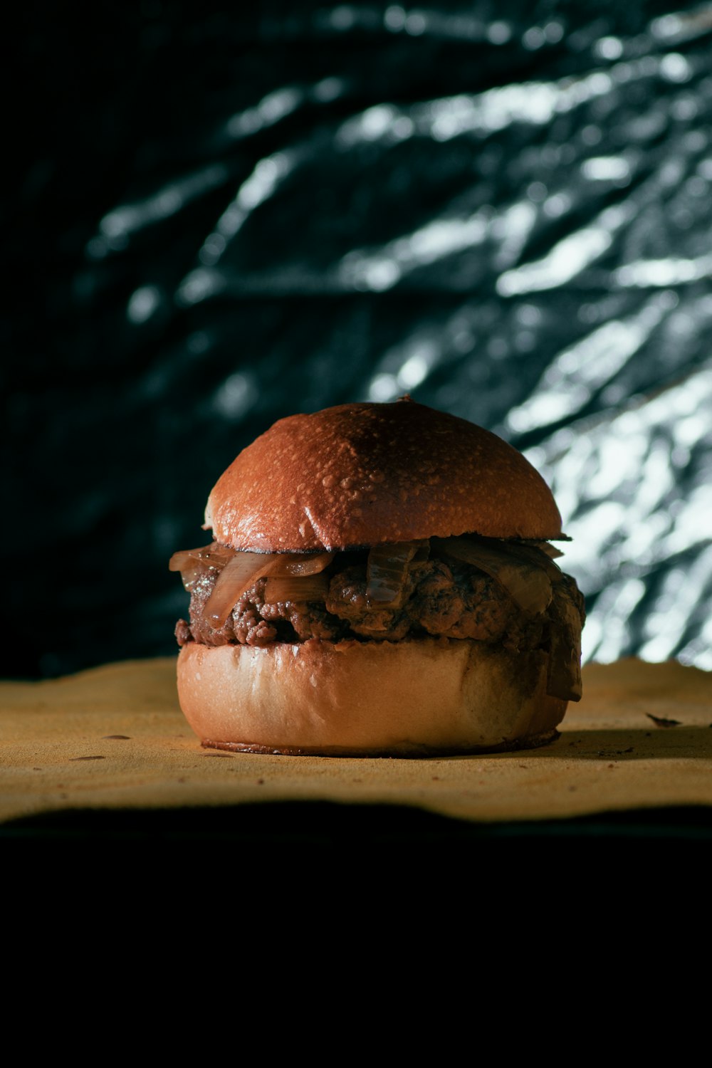 a hamburger sitting on top of a wooden table