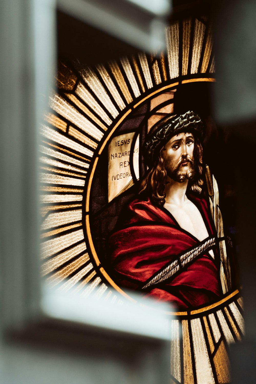 a close up of a stained glass window with jesus