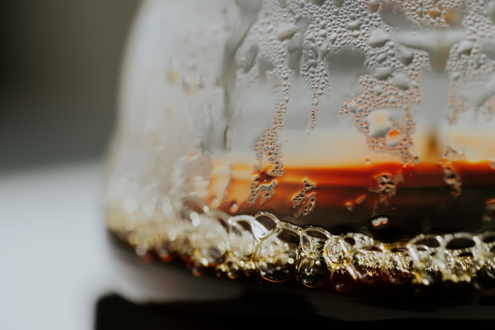 a close up of a glass with liquid inside of it