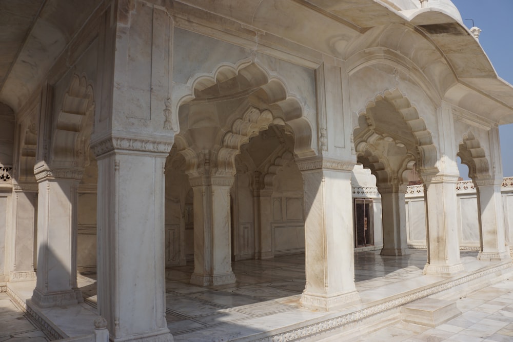 a large white building with pillars and arches