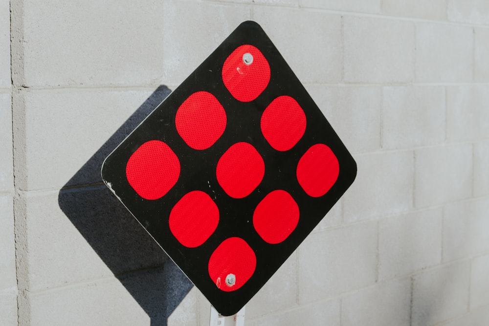 a close up of a red and black traffic sign